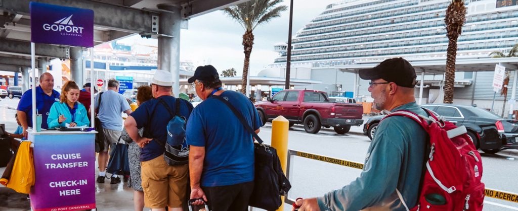 Line of cruise passengers getting on Go Port shuttle after disembarking at Port Canaveral