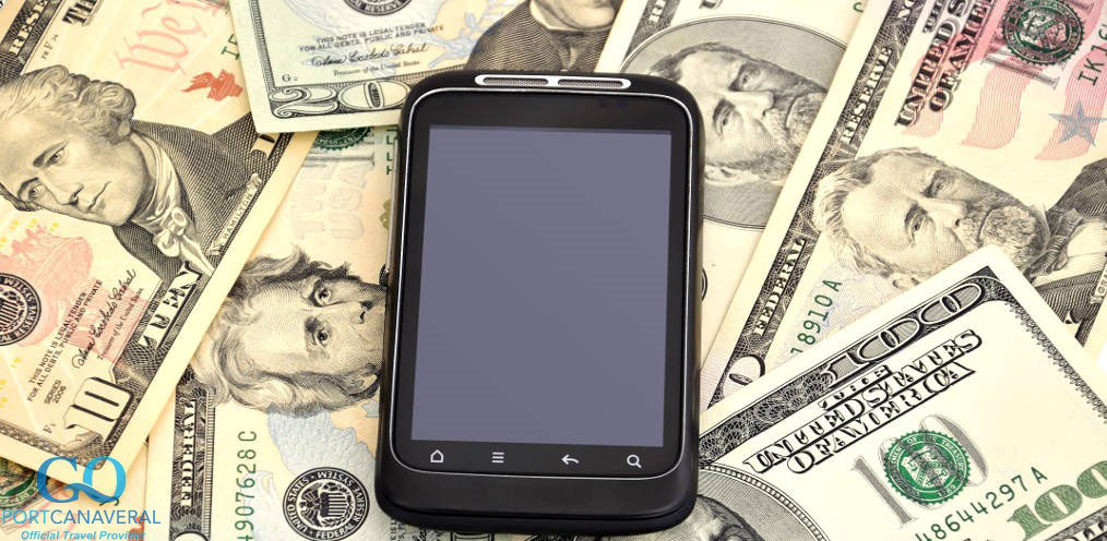 touchscreen mobile phone and dollars on white background