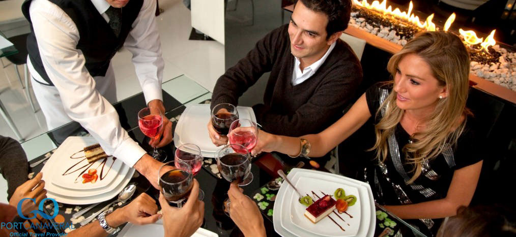 Group of people being served dinner by a waiter