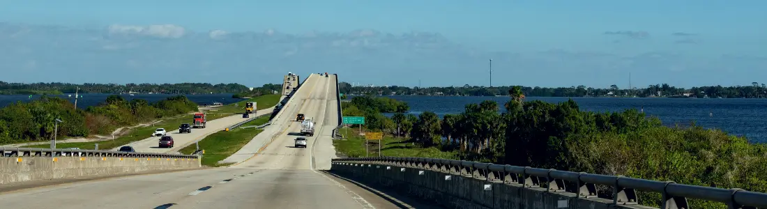 view of cars driving over bridge to Port Canaveral