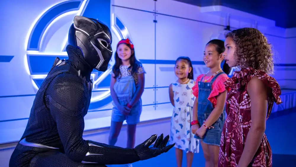 Costumed performer talking to four kids at Marvel Super Hero Academy kids club on Disney Treasure Cruise