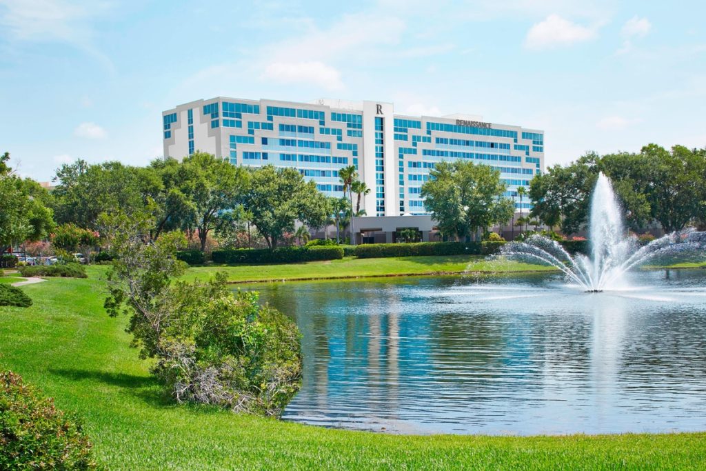 Exterior view of Renaissance Orlando Airport hotel with lake in front