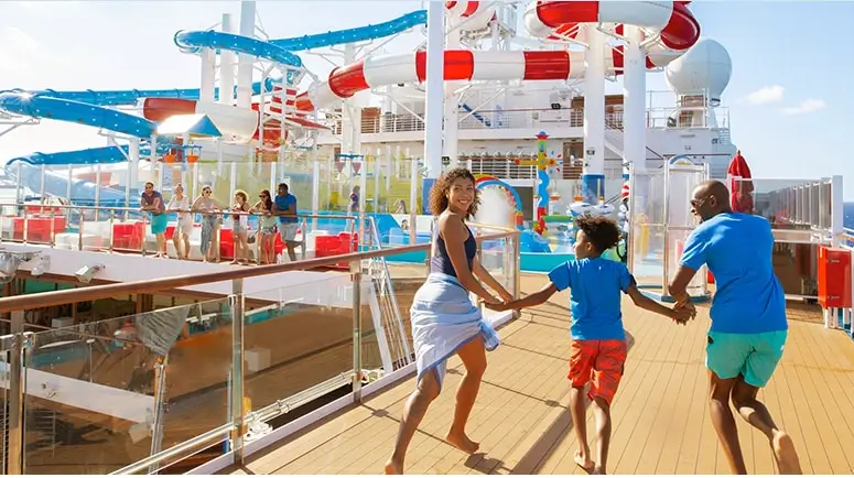 family running towards water slides on Carnival Venezia cruise ship